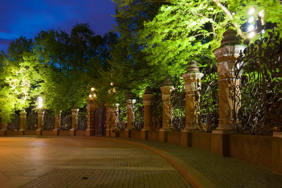 A well lit mansion's gated architecture.